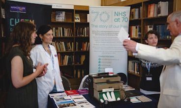 Postgraduate students taking part in a public event.